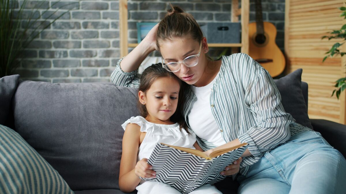 A grandfather and grandson reading together