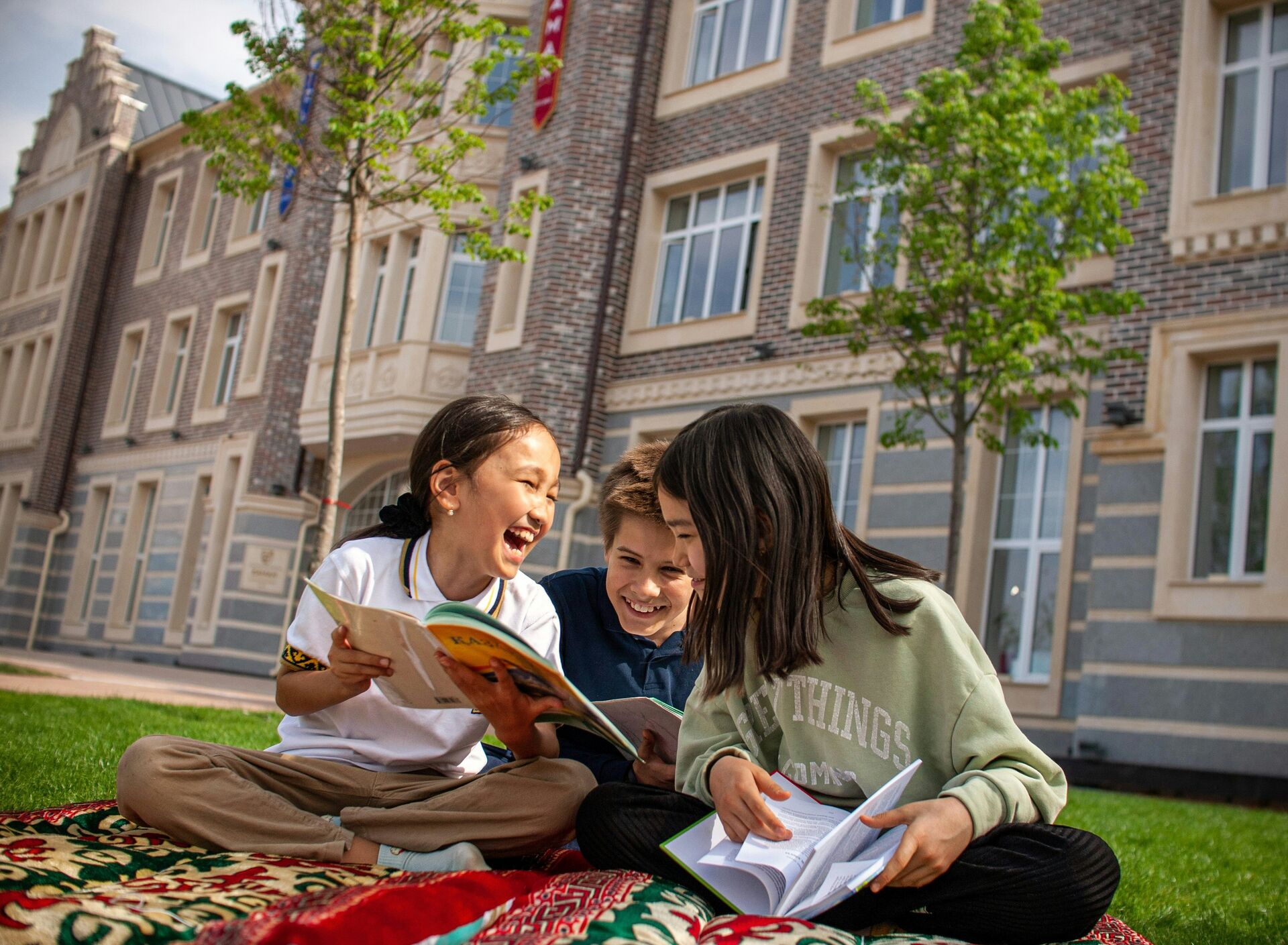 Children reading together outdoors