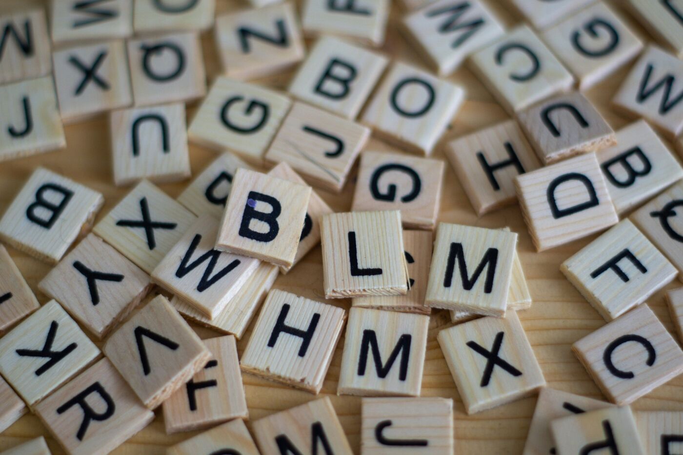 Wooden letter tiles scattered on a table