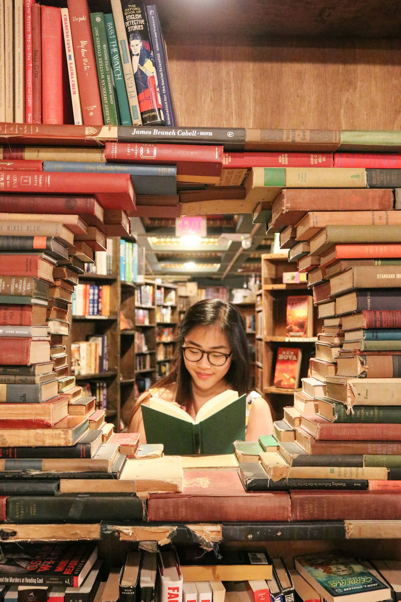 A student reading inside a fort of books